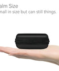 Hard Protective Earphone Case For Earbuds And Headphones Ultra Compact Carrying Pouch shown on an open palm, black.
