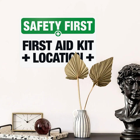 First Aid Kit Location Warning Sign 8x12 Metal Marker Plaque in decor setting with vase and sculpture.