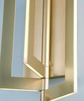 Close-up of Slick Modern Wall Sconce With Asymmetrical Fan Frame LED Light Featuring Water Mill Inspired Gold Finish.