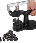Watch Press Tool 18mm To 50mm with black alloy frame and 12 dies, shown with a hand operating the clamp for watchmaking.