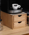 Double Tier Wooden Coffee Maker Stand With Pull Out Storage Drawer For K Cups And Capsules Countertop Brew Organizer Rack close up with a coffee cup.