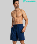Model wearing navy 9 Inch Mens Quick Dry Swim Trunks With Liner For Full Coverage Water Shorts Perfect For Beach Ready Poolside Hikes
