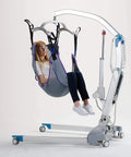 The Ultimate Patient Aid Full Body Mesh Sling For Safe And Effortless Bed To Wheelchair Transfers With Reinforced Straps supporting a user in a lifting device.