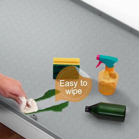 Under Sink Silicone Mat 28 By 22 Inch Waterproof Flexible Liner With Drain Hole Gray for kitchen cleanup demonstration with spills.