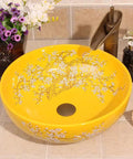 Top Tier Yellow Floral Ceramic Vessel Sink For Bathroom Countertop Featuring Handmade Artistry with center drain and glossy finish.