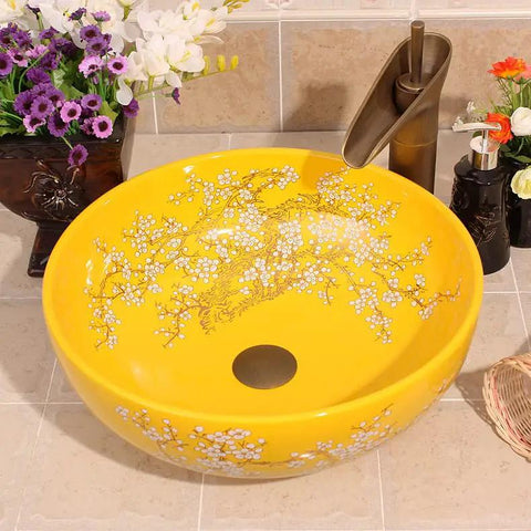 Top Tier Yellow Floral Ceramic Vessel Sink For Bathroom Countertop Featuring Handmade Artistry with center drain and glossy finish.