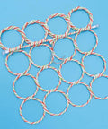 Foldable Paper Rattan Scarf Hanger Featuring 20 Rings And Sturdy Steel Hook, colorful woven loops on blue background.