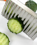 Close-up of two-pack stainless steel crinkle cutter with a wavy blade for slicing cucumbers and carrots.