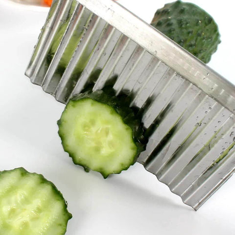 Close-up of two-pack stainless steel crinkle cutter with a wavy blade for slicing cucumbers and carrots.