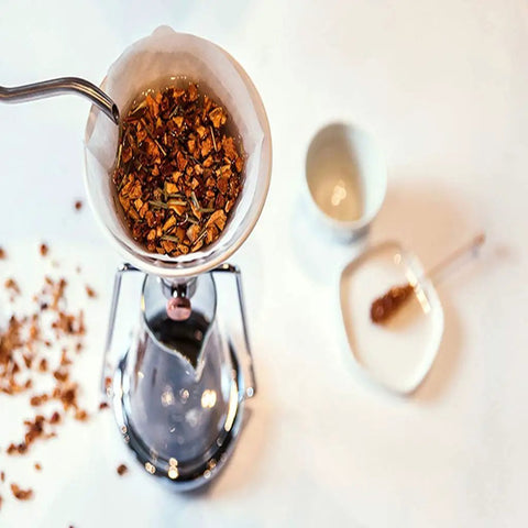 Elevate Your Daily Grind With This Dope 3-In-1 Coffee Kettle, Cold Brew And Ice Drip Maker, Manual Filter Teapot For Smooth Lattes And Cappuccinos, Matte Black Finish. Close-up of coffee grounds in filter.