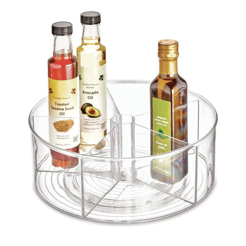 Recycled Plastic Lazy Susan Spin Turntable Organizer For Pantry And Bathroom, 11.5 Inch Clear, with divided sections holding bottles.