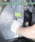 Front view of a gloved hand using a green seam roller on automotive PU sound-deadening mat inside a car.