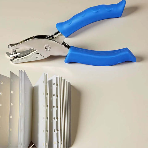 Photo of Blue One Circle Hole Punch With Soft Grip Handheld Paper Punch for crafts and card making next to punched paper samples