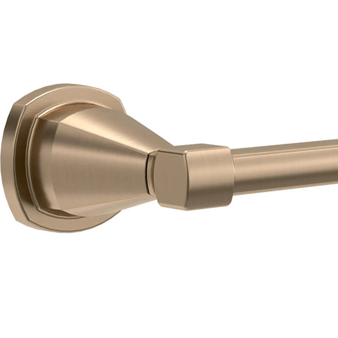 Close-up of a pivoting toilet paper holder in champagne bronze finish wall mount bathroom accessory durable corrosion resistant hardware that holds any sized roll easy replacing secure pivot arm for quick one handed change.