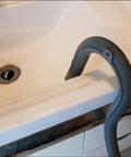 U Shape Drain Hose Holder For Washer And Dishwasher 2 Pack Gray Plastic Wall Mount Bracket installed over a sink edge