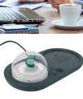 Smart Electric Cup Warmer Base With Three Adjustable Heat Modes To Keep Your Favorite Drinks Piping Hot While You Knock Out Tasks At Home Or In The Office on a desk with a coffee cup.