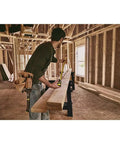 Man using FatMax Auto Lock Tape Measure 25 Ft With 1-1/4 Inch Wide Blade Detachable End Hook Quick Lock in construction site