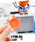 Flexible Jaw Coupling Insert With Rubber Spider For Vibration Dampening In CNC Machines, shown held in hand near equipment