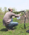 Person setting up Replacement Magnum Rifle Gong With AR550 Steel Construction for outdoor shooting range practice.
