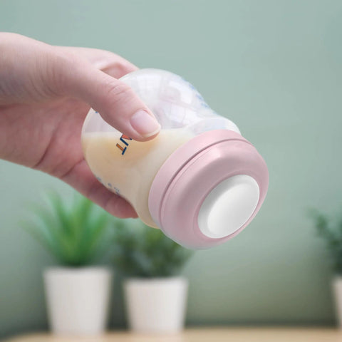 Hand holding bottle with pink Travel Caps With Rewritable Sealing Disc For Avent Wide Mouth Bottles, Leak Resistant Screw Lids