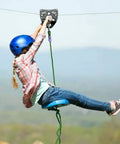 Child using Beefy Tandem Speed Double Pulley System For Zip Lines 45kN Break Load High Tensile Steel Alloy Fits 9 To 13 mm Cable outdoors.