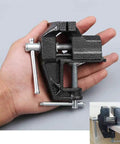 Hand holding Handy Little 2.4 Inch Mini Table Clamp Bench Vise Made From Durable Cast Iron with inset of vise mounted on table