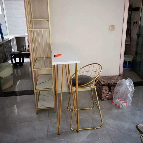 Rock Solid X Frame Steel Pipe Table Legs For Coffee Tables And Bars in a home setting with a white top and gold finish.
