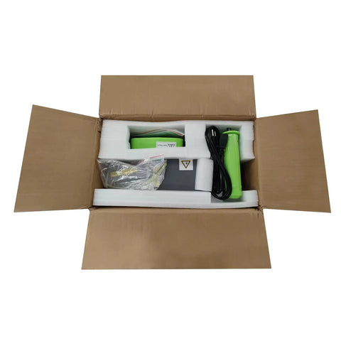 Compact Air Pillow Maker Machine unboxed with components including user manual and plastic roll, ready for use.