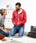 Couple using 208 Piece Screwdriver Bit Set With Security Bits in a living room, open case showing chrome vanadium steel tools
