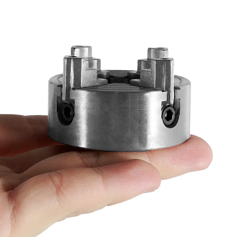 Top Tier Heavy Duty Four Jaw Mini Lathe Chuck Kit Featuring Rock Solid Zinc Alloy Construction, compact size in hand.