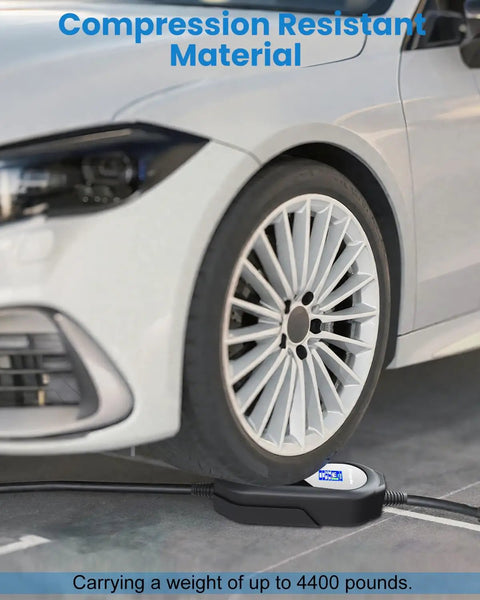 Badass Range Ready Portable EV Charger With Adjustable 16A Current 21 Ft J1772 Cable Smart Delay Timer and Color LED Touchscreen on a car tire.