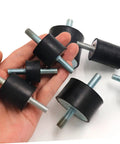 Heavy Duty Round Rubber Vibration Damping Mounts Four Pack in hand, showcasing black rubber pads with steel bolts.