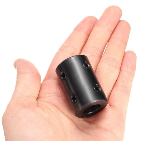 Rigid Shaft Coupling With Five Eighth Inch Bore And One And One Quarter Inch Outer Diameter Two Inch Length Black Oxide Carbon Steel shown in hand
