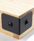 Corner view of 4 Pack Heavy Duty Iron Corner Protectors 2x2x1.5 Inch Black Decorative Corner Brackets for furniture wood frames.