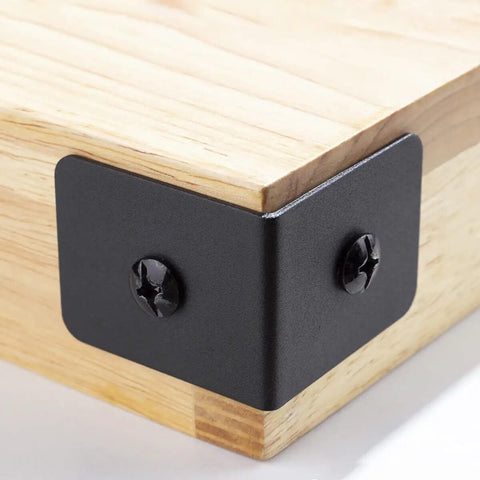 Corner view of 4 Pack Heavy Duty Iron Corner Protectors 2x2x1.5 Inch Black Decorative Corner Brackets for furniture wood frames.