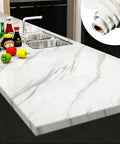 White Marble Contact Paper For Countertops Waterproof Self Adhesive Marble Wallpaper Peel And Stick Kitchen Counter Wrap 30x118 Inches Glossy Finish Covers 24.54 Sq Ft No Fuss Trim, applied on a kitchen countertop near a sink with groceries.