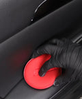 Gloved hand using red foam pad from 10 Pack Foam Wax Applicator Pads For Car Detailing on leather interior