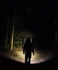 Hiker illuminated by Archer 2A V3 LED Flashlight With Dual Switches Beefy 500 Lumens AA Powered IPX8 Waterproof Handheld Light beam