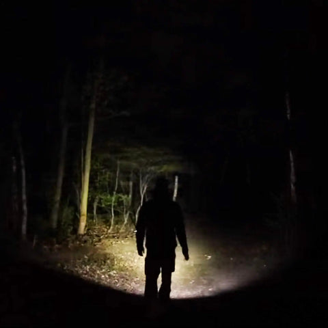 Hiker illuminated by Archer 2A V3 LED Flashlight With Dual Switches Beefy 500 Lumens AA Powered IPX8 Waterproof Handheld Light beam