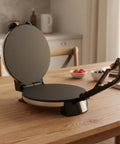 Baoblaze Electric Pancake Maker Nonstick Hinged Flatbread Press on wooden table, black design for easy cooking.
