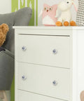 Slick One Point Three Seven Inch Marble Look Cabinet Knobs Four Pack on white dresser with toys, showcasing stylish storage.