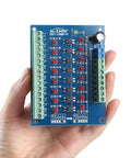 Hand holding an 8 Channel Optocoupler Isolation Board No Fuss 24V To 3.3V Level Shifter For PLC and MCU Signals PNP Output Photoelectric