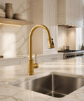 Gold Brushed Nickel Kitchen Faucet with Pull Down Sprayer, 3 Mode Sprayer installed over a stainless steel sink.