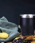 Built Tough 304 Stainless Steel Insulated Travel Mug with cookies and coffee beans, ideal for on-the-go drinks.