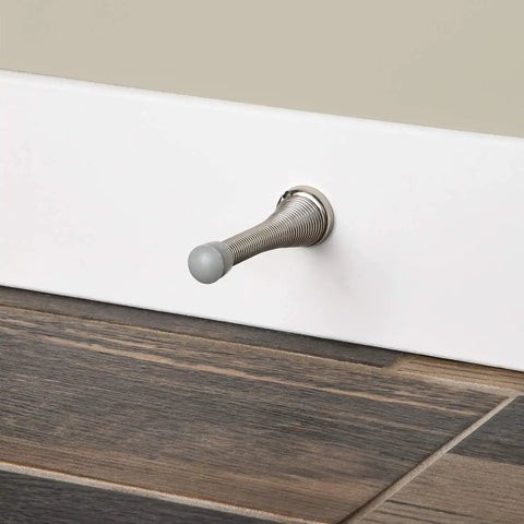 Heavy Duty Brushed Nickel Spring Door Stop With Rubber Bumper Tips, Spring Steel Construction, About Three Inches Long, installed