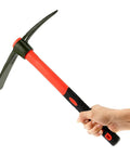 Hand holding 15 Inch Forged Steel Pick Mattock Hoe With Fiberglass Handle For Digging Gardening Camping Prospecting And Construction Work A Beast Weeding Tool Built For Tough Jobs