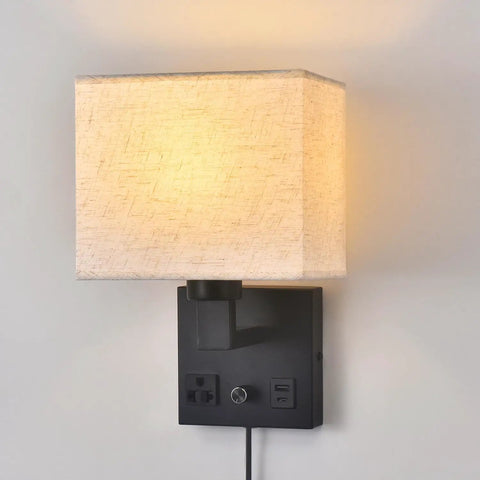 Plug In Wall Sconce Hits Different With Touch Dimmer, matte black metal base, soft cream fabric shade, USB port and AC outlet.