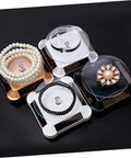 Solar Powered Rotating Jewelry Display Stand With Built In Kickstand showcasing pearl and decorative bracelets on sleek ABS risers.