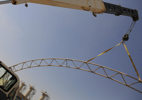 1 Inch by 4 Foot Flat Loop Eye to Eye Lifting Sling with Protective Sleeve lifting a metal structure on crane