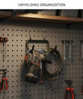 Heavy Duty Carbon Steel Pegboard Hooks For Garage Organization And Workshop Setup, holding tools on perforated board.